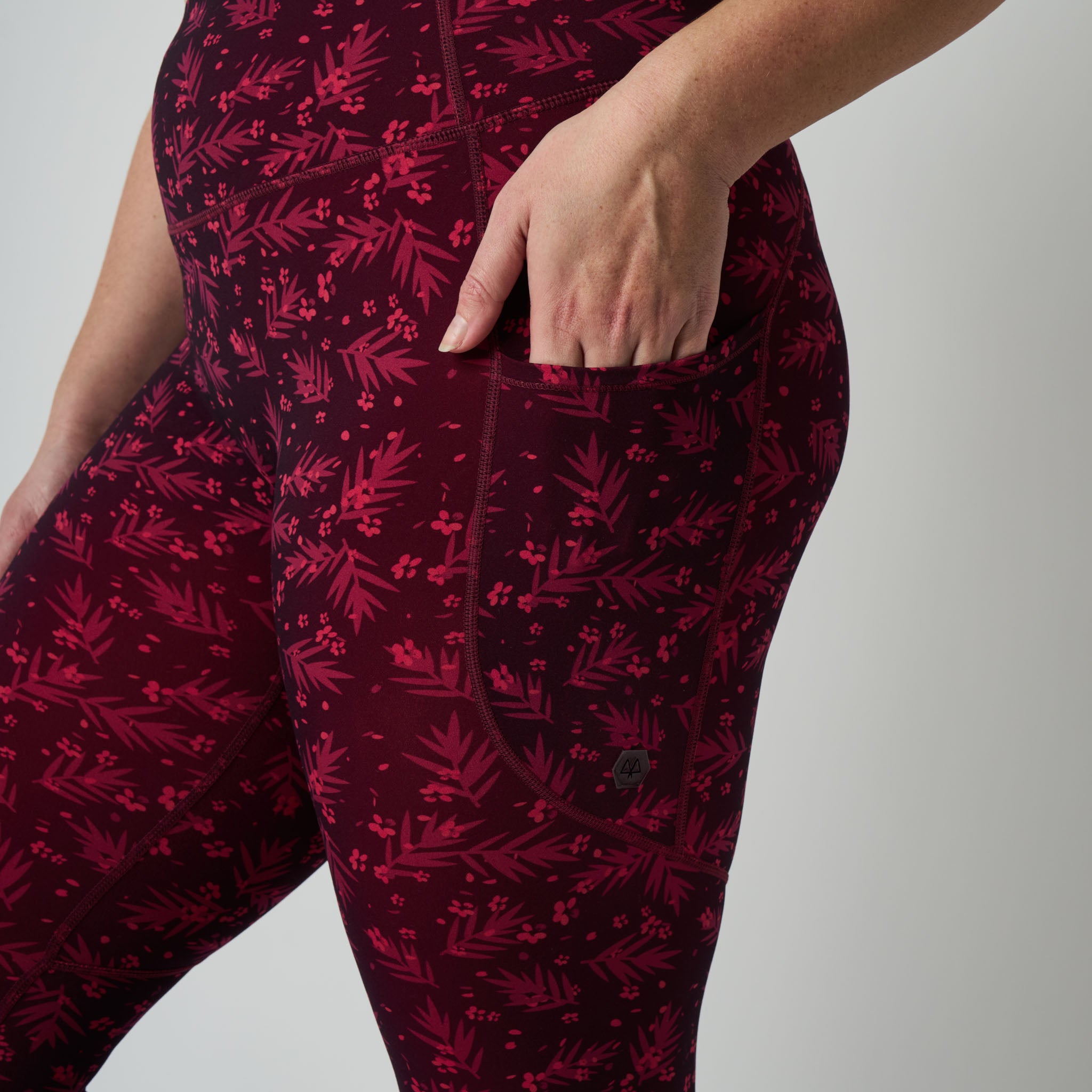 Dark red pants with a subtle pattern on a light gray background