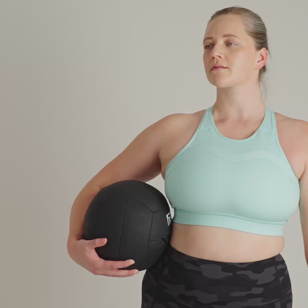 Person wearing a light blue sports bra with a plain background