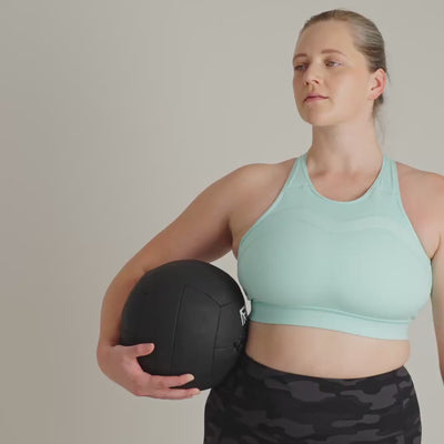 Person wearing a light blue sports bra with a plain background